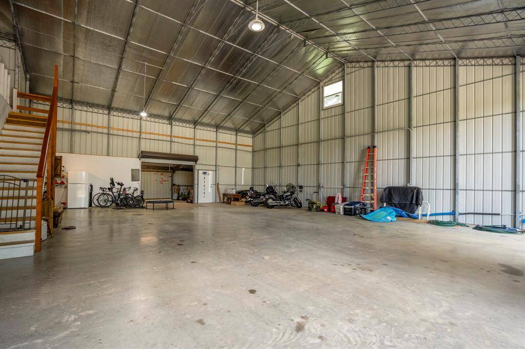 Adjacent to the house is the OVERSIZE garage space.  The space can accommodate up to 9 cars, or there is enough space for RV storage.