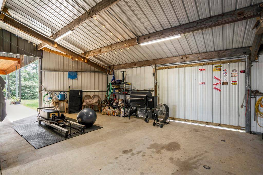 The back of the garage features a workshop area.  Can be used for woodworking, working out, or whatever you can dream up!  Two sliding doors open and provide natural light and a view of outside.