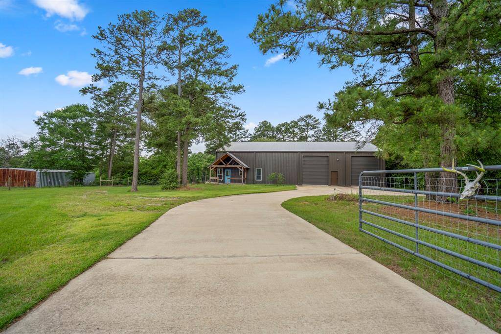 Extra long driveway with security gate, perfect for privacy and nature lovers.