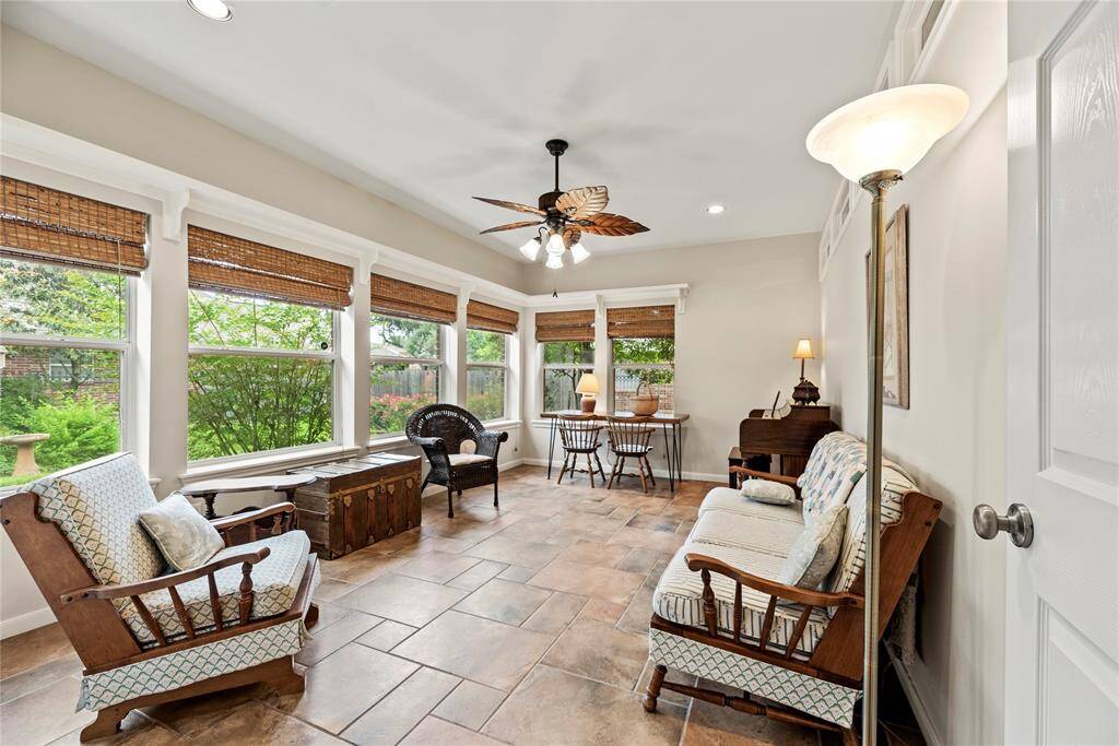 Just beyond the living area lies the perfect sunroom—a light-filled retreat ideal for relaxing, reading, or enjoying morning coffee.