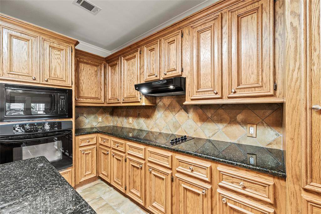 Rich cabinetry offers a clean, timeless aesthetic that elevates the space with a sense of brightness and openness.