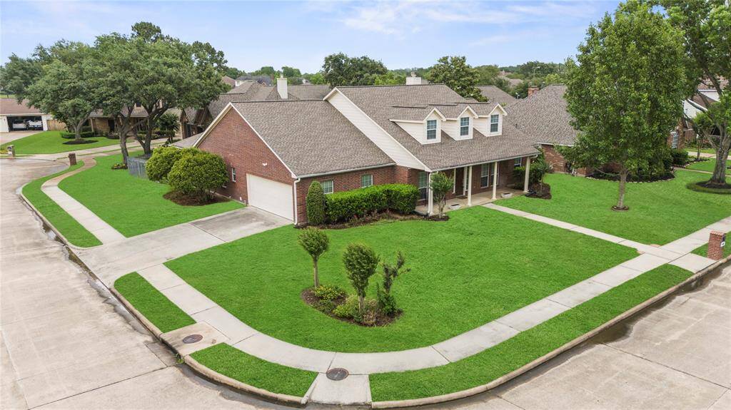 Take in this stunning aerial view of a spacious corner lot, beautifully positioned with a convenient side entrance to the garage.