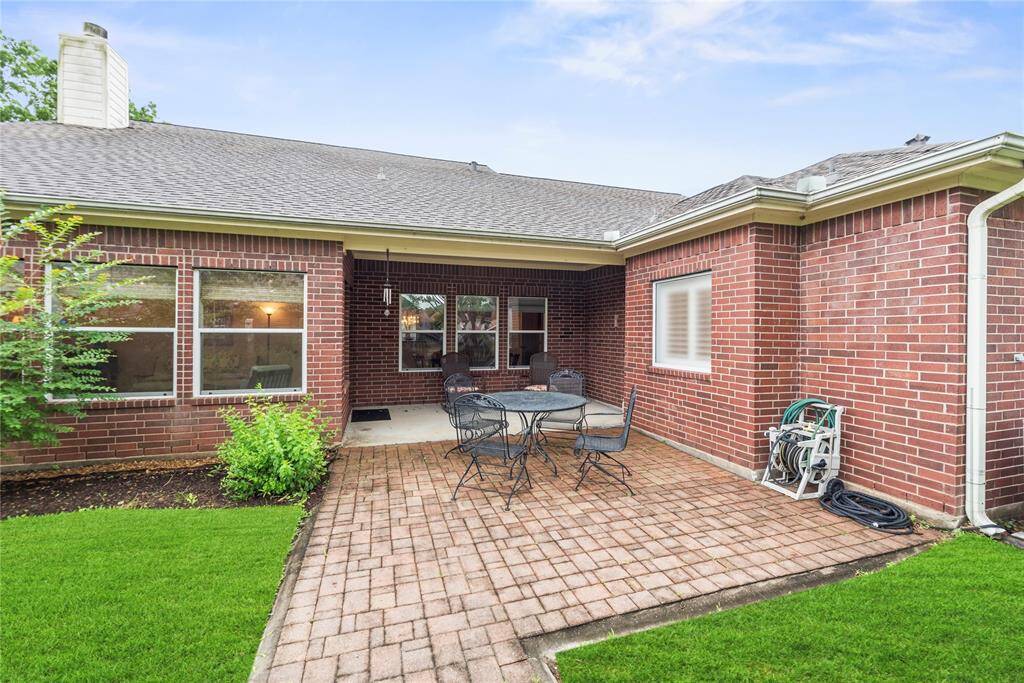 Step into the backyard, where a beautifully tiled patio provides the perfect setting for outdoor dining, relaxation, and entertaining.