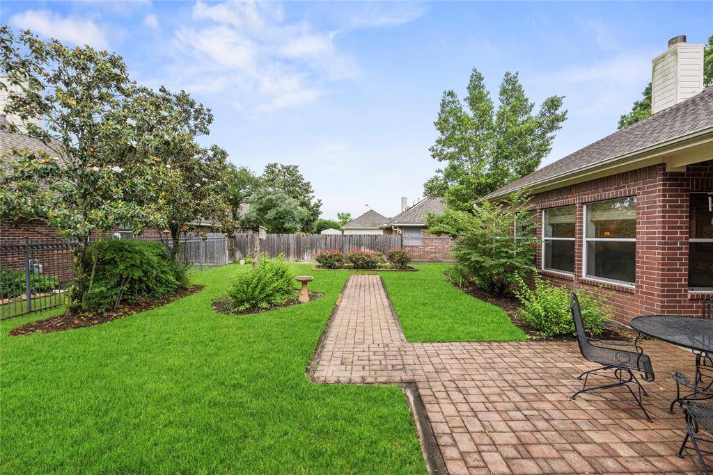 Beautifully landscaped and generously sized, the backyard is enhanced by lush greenery and mature trees that offer both shade and serenity.