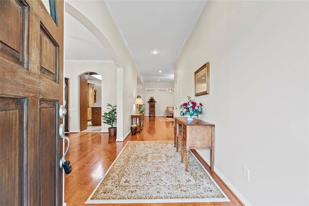 Step into the inviting foyer, where rich hardwood floors offer a warm and elegant welcome.