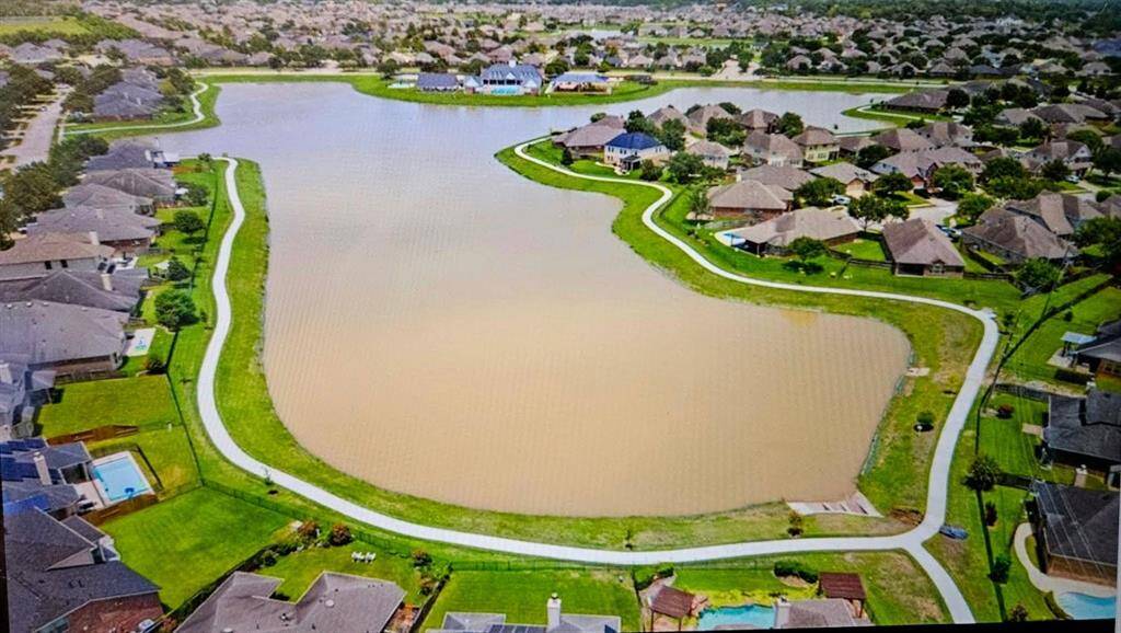 A sweeping aerial perspective shows the lake-centered neighborhood, with manicured landscapes and water vistas that enhance the peaceful setting.