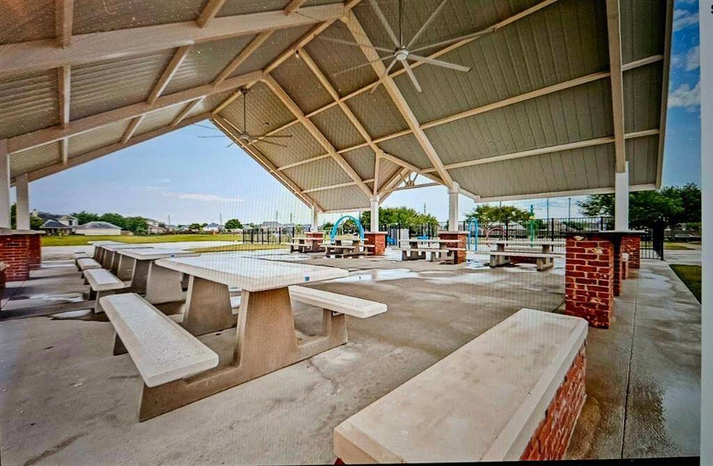 A generous open-air pavilion with picnic tables offers a breezy spot to relax, host get-togethers, or unwind under shelter while staying connected to the community’s scenic surroundings.