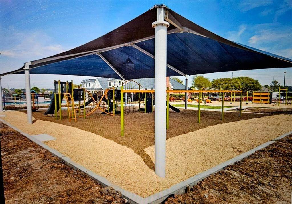 A large covered playground provides year-round fun and shade, with plenty of room for active play and gathering under the spacious canopy.