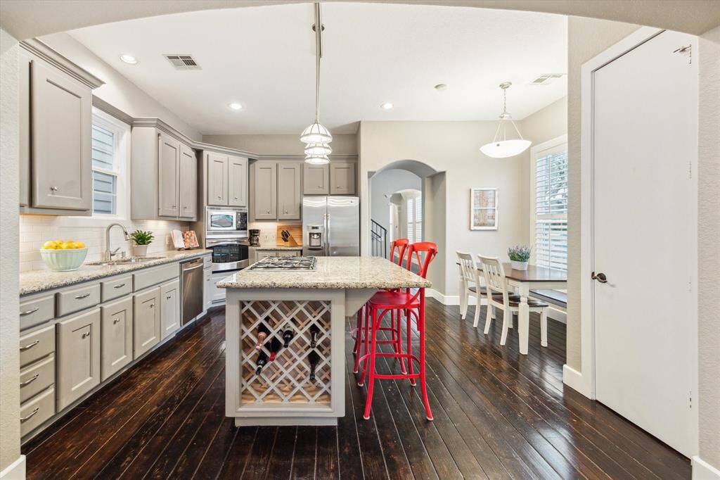 The kitchen is a cook’s dream with a gas cooktop, convection oven, stainless steel appliances, under-cabinet lighting and a water filtration system.
