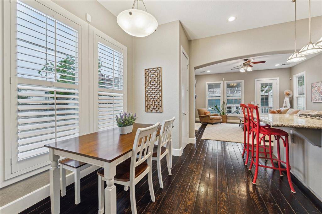 The breakfast area is thoughtfully positioned opposite the kitchen. Bathed in natural light from the windows, this inviting space provides the perfect setting for enjoying meals.