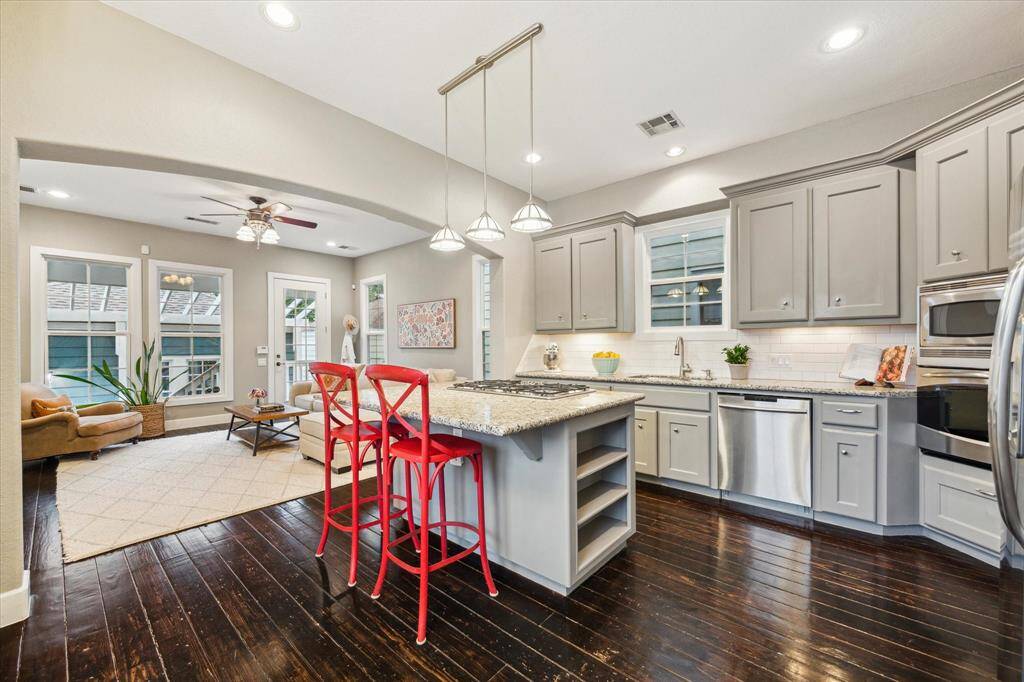 The kitchen offers ample storage, including within the island and a walk-in pantry.