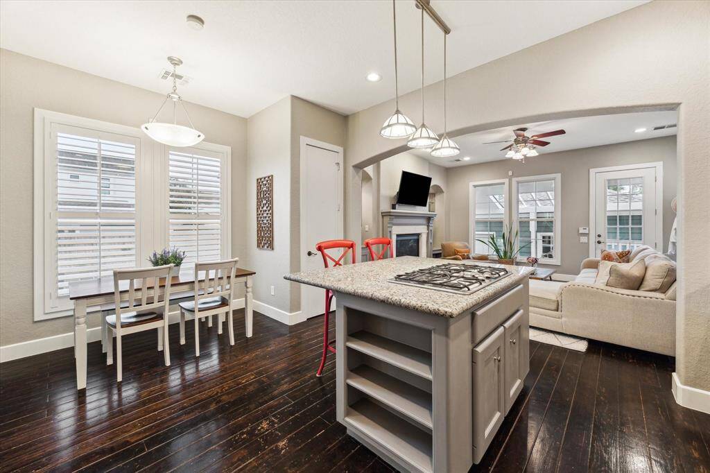 The gas cooktop on the island makes it easy to cook while entertaining or keeping an eye on loved ones.