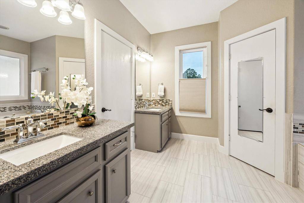The ensuite bath features a walk-in closet, jetted tub, separate shower, and water closet.