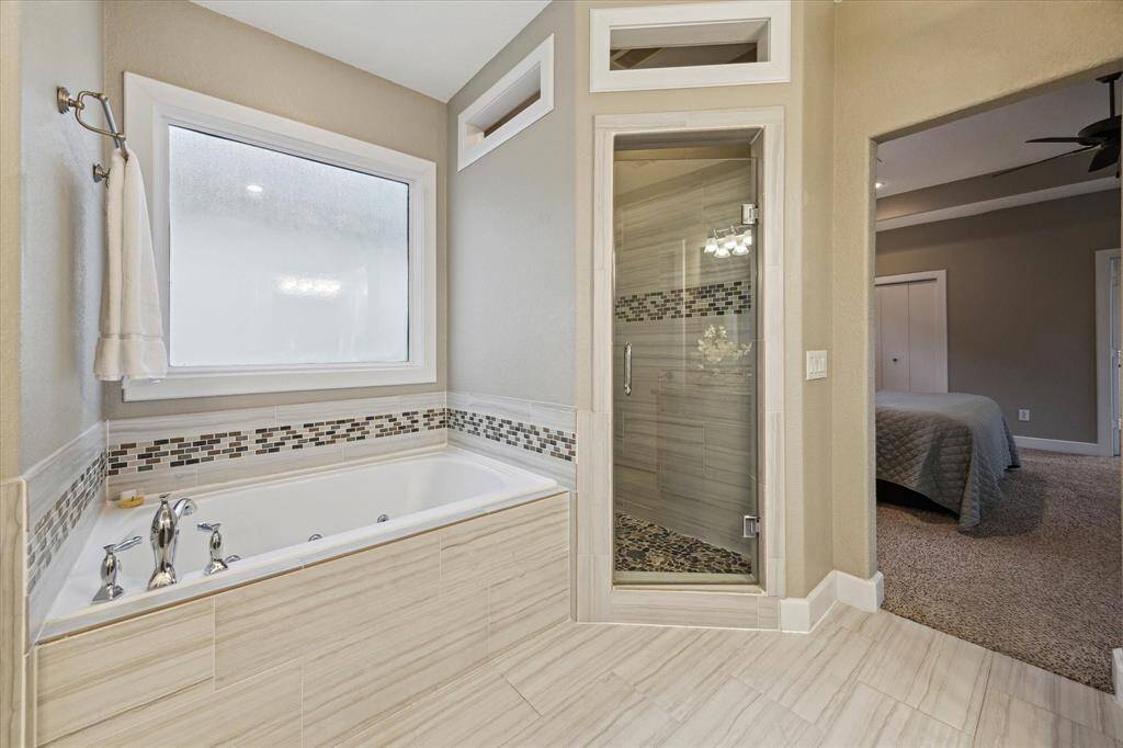 Unwind in the jetted tub or glass-enclosed shower—your perfect retreat to relax and rejuvenate.
