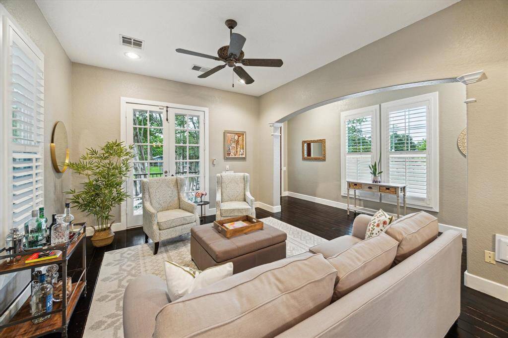 Formal dining room with windows on both sides allowing natural light into the room as well as French doors leading to the front porch.