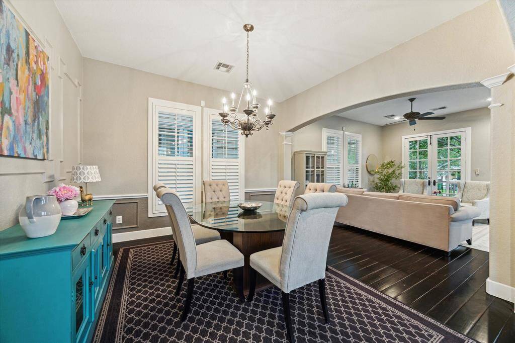 The spacious dining room is anchored by a chandelier and is bathed in natural light.