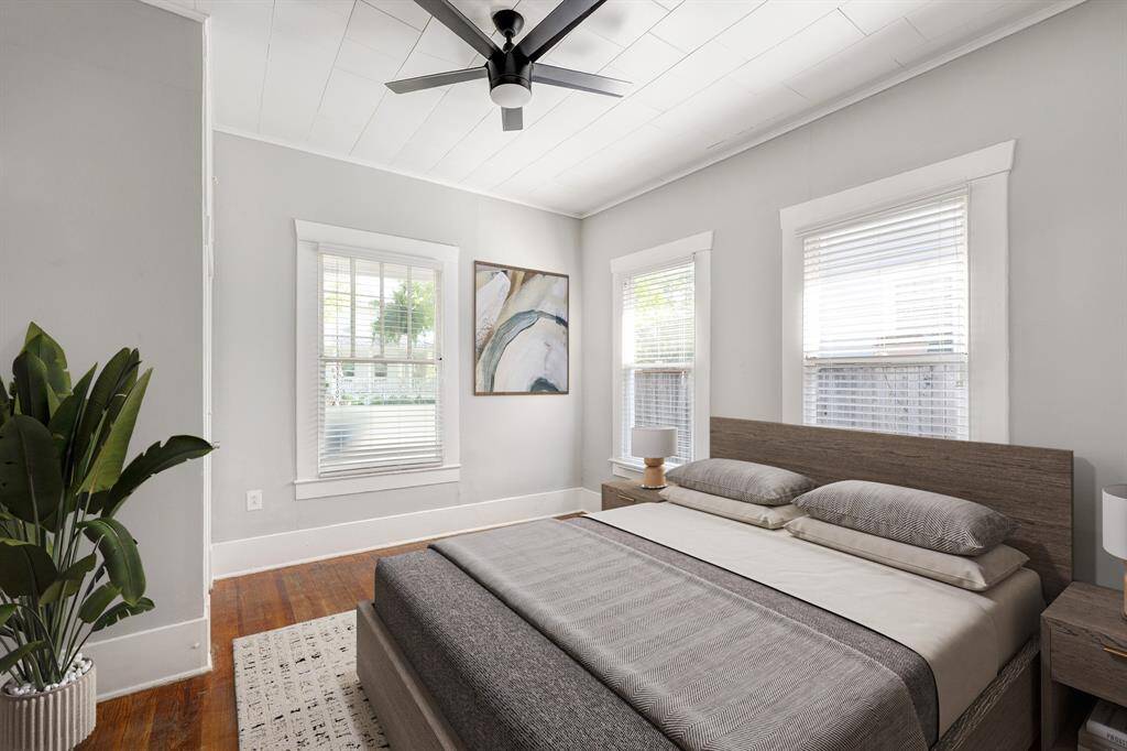 Front bedroom with window treatments and 10 foot ceilings. (Virtually Staged)