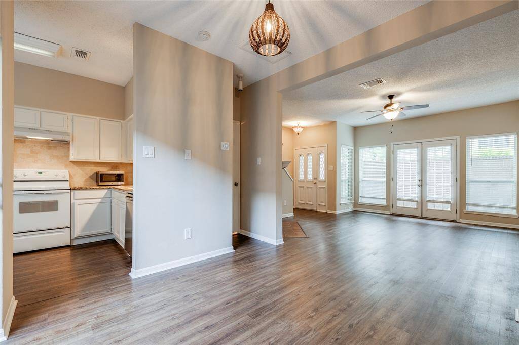 This open layout allows for plenty of natural light, flowing seamlessly from the living area to the dining space and kitchen. It accommodates your furniture, enabling easy movement between spaces.