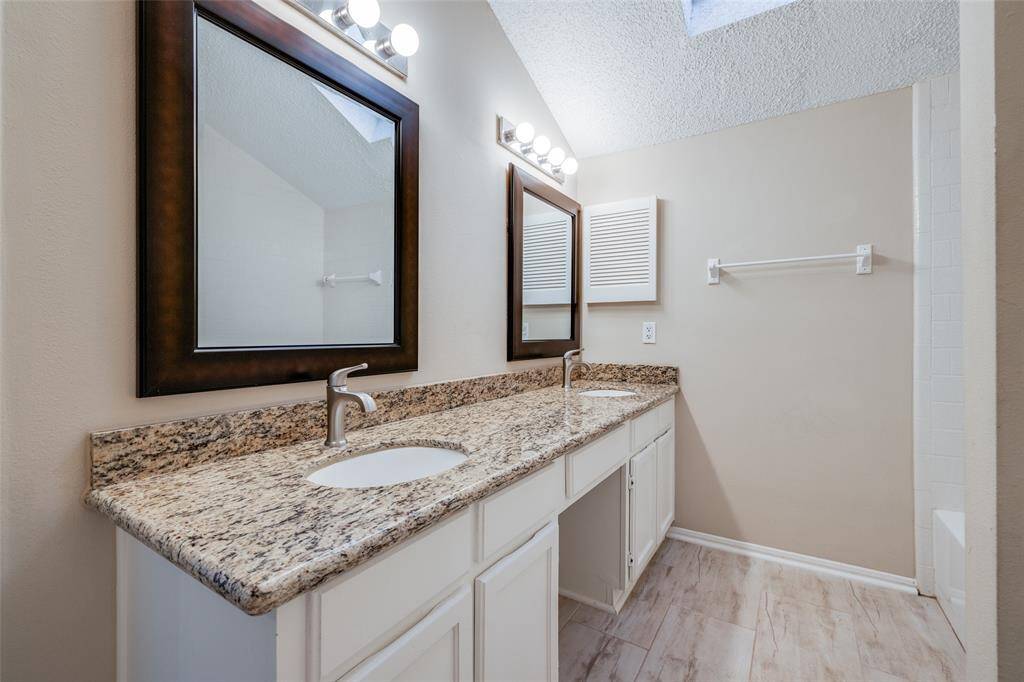 The secondary bathroom features double sinks!