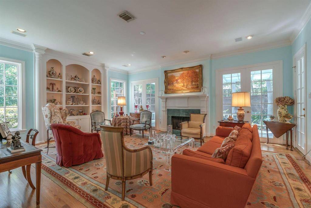 Family room being used as a formal living room. Fireplace. Large windows. Hardwood floors.
