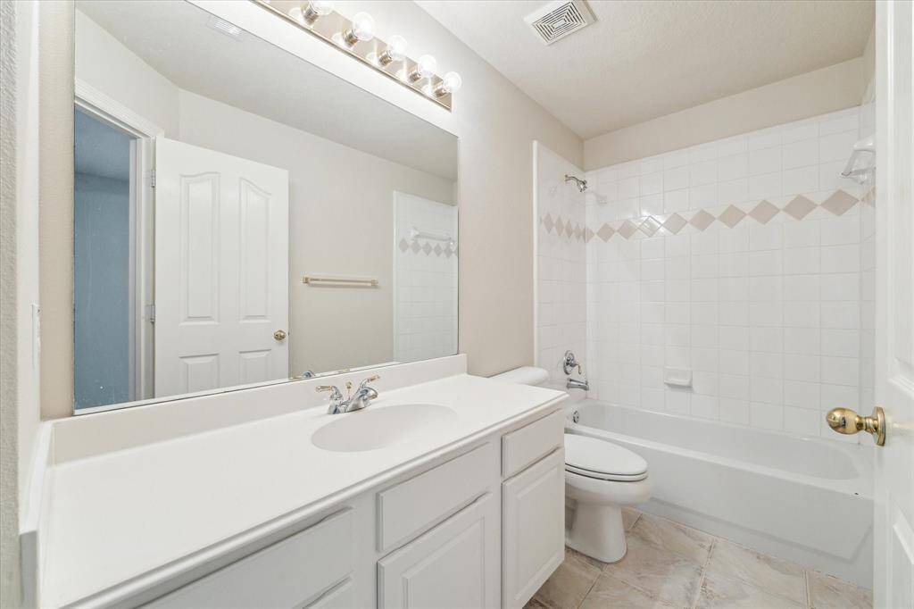 The shared secondary bathroom is located off the hallway, providing convenience for both areas.