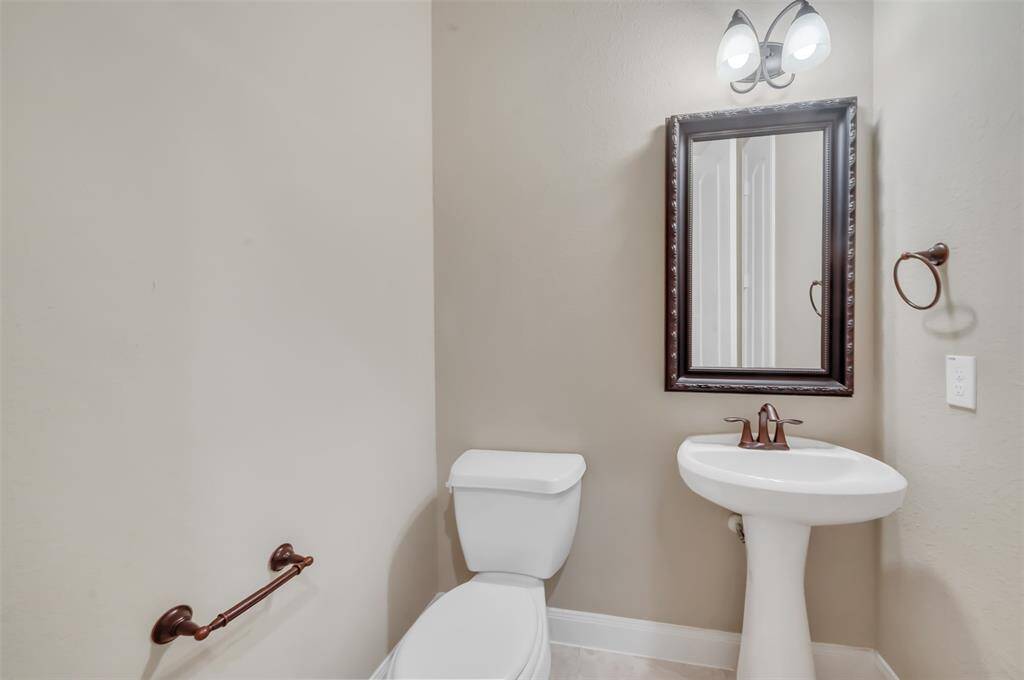 Thoughtfully placed in a convenient location, this powder room blends functionality with elegance.