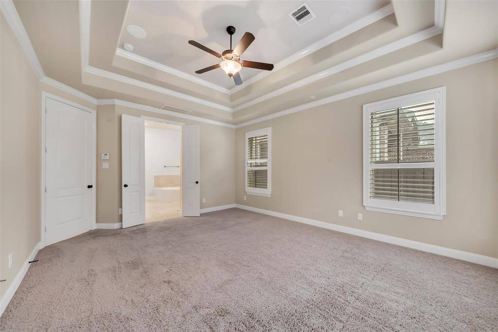 Soft carpet flooring adds a cozy touch, while the ceiling fan ensures comfort year-round. The room offers plenty of space for relaxation, providing a peaceful retreat at the end of each day.