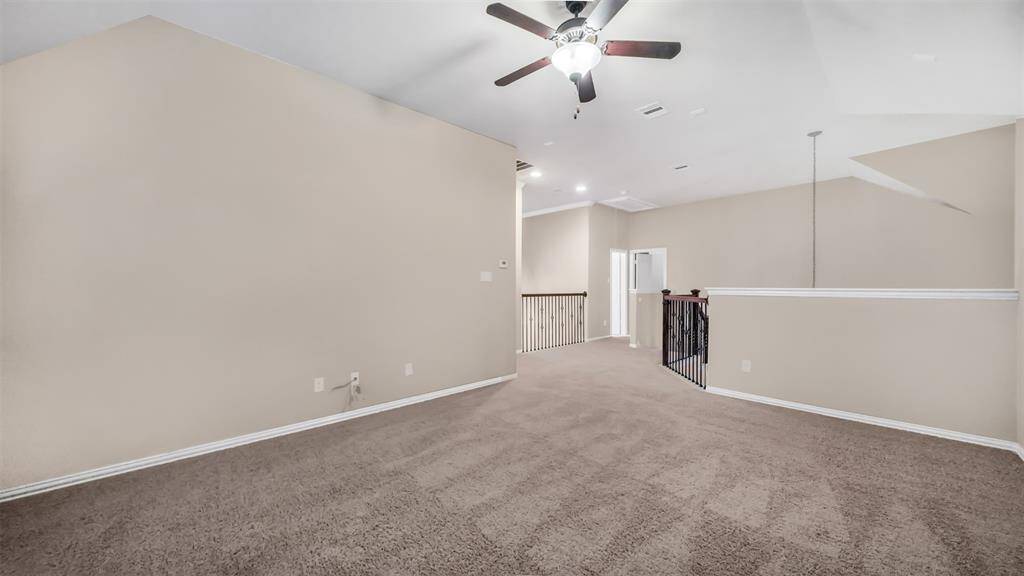 Upstairs game room offers plenty of space for entertainment and relaxation, perfect for hosting game nights or creating a fun, multifunctional area for the whole family