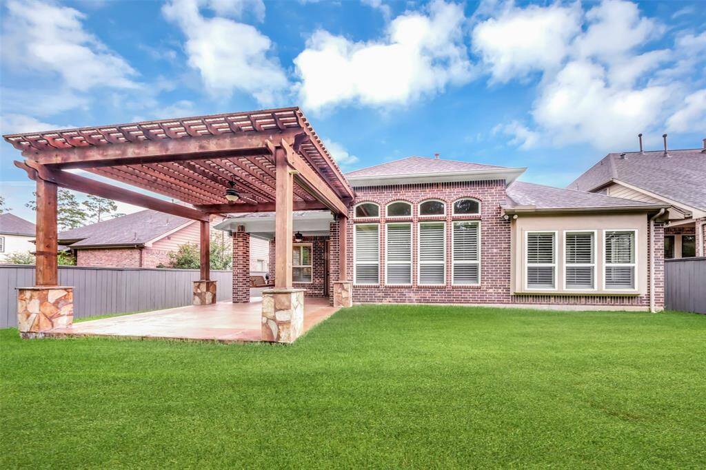 Enjoy the outdoors in this large backyard featuring a fully covered patio, perfect for gatherings or quiet relaxation.