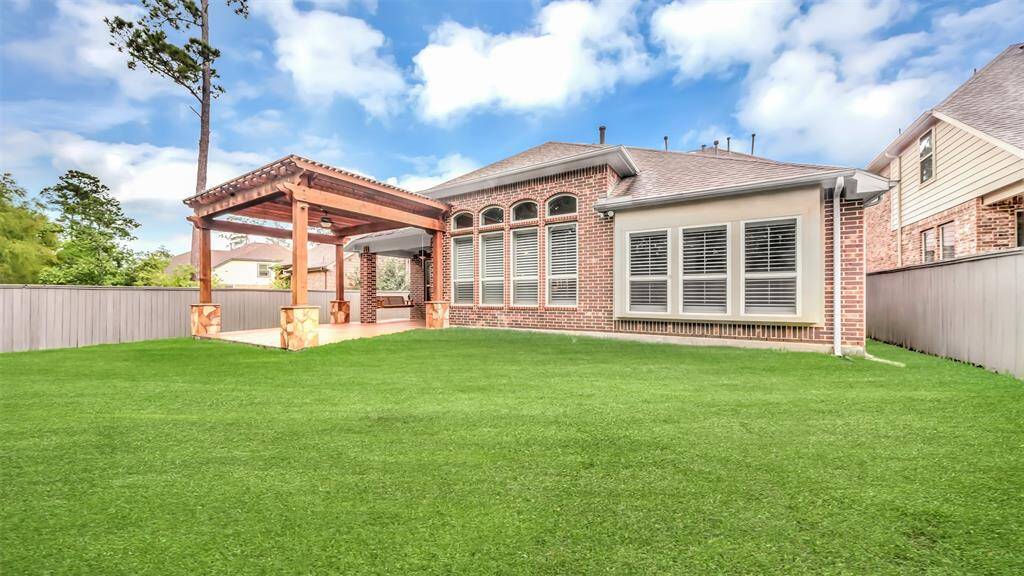 The spacious backyard offers plenty of room for outdoor activities and relaxation.
