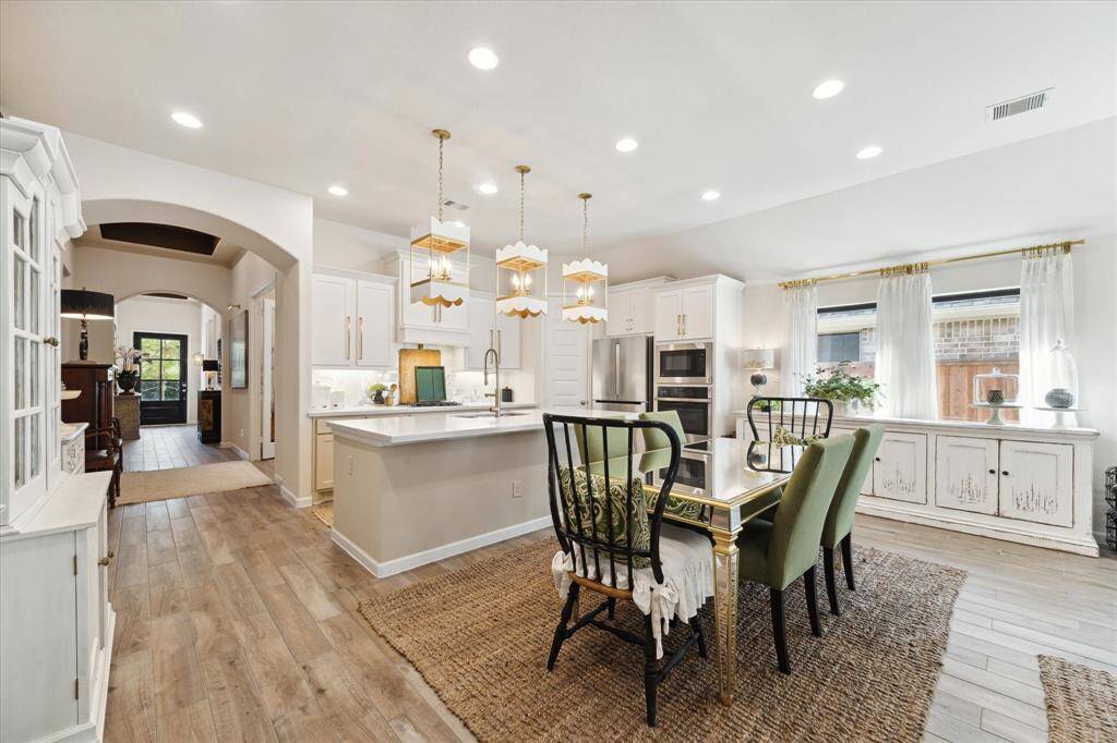 View of the kitchen and dining area tucked around the corner from the main entry hall.