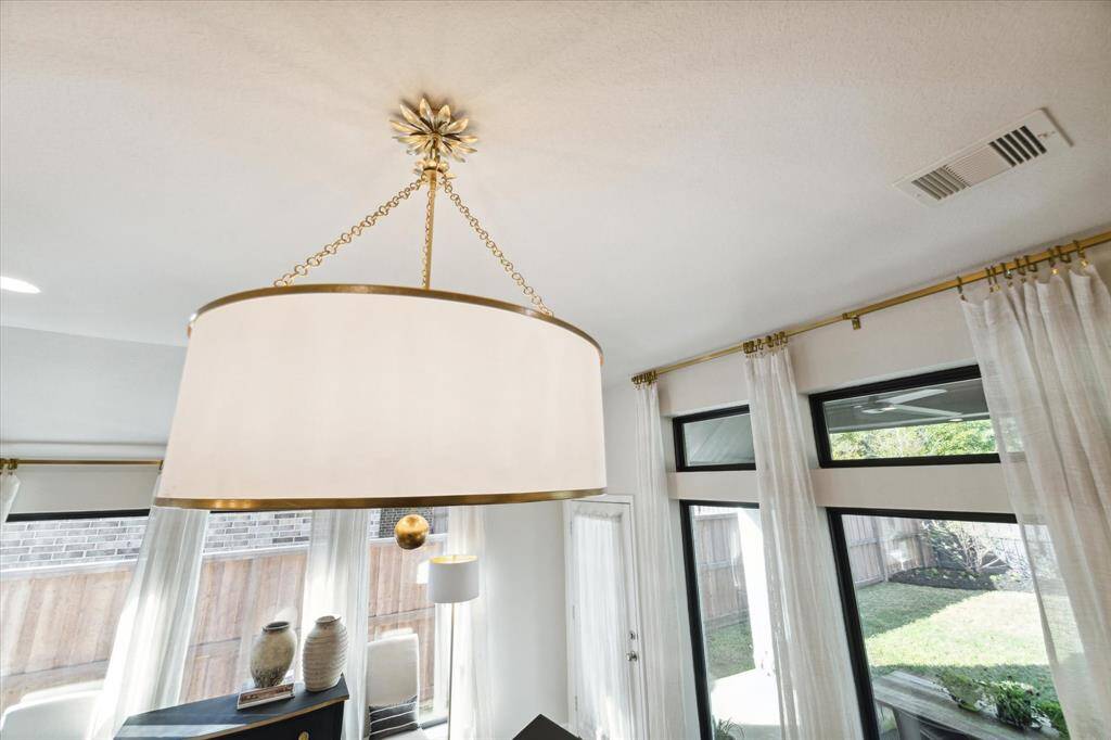 The overhead light fixture is a timeless centerpiece in the living room and stays with the home.