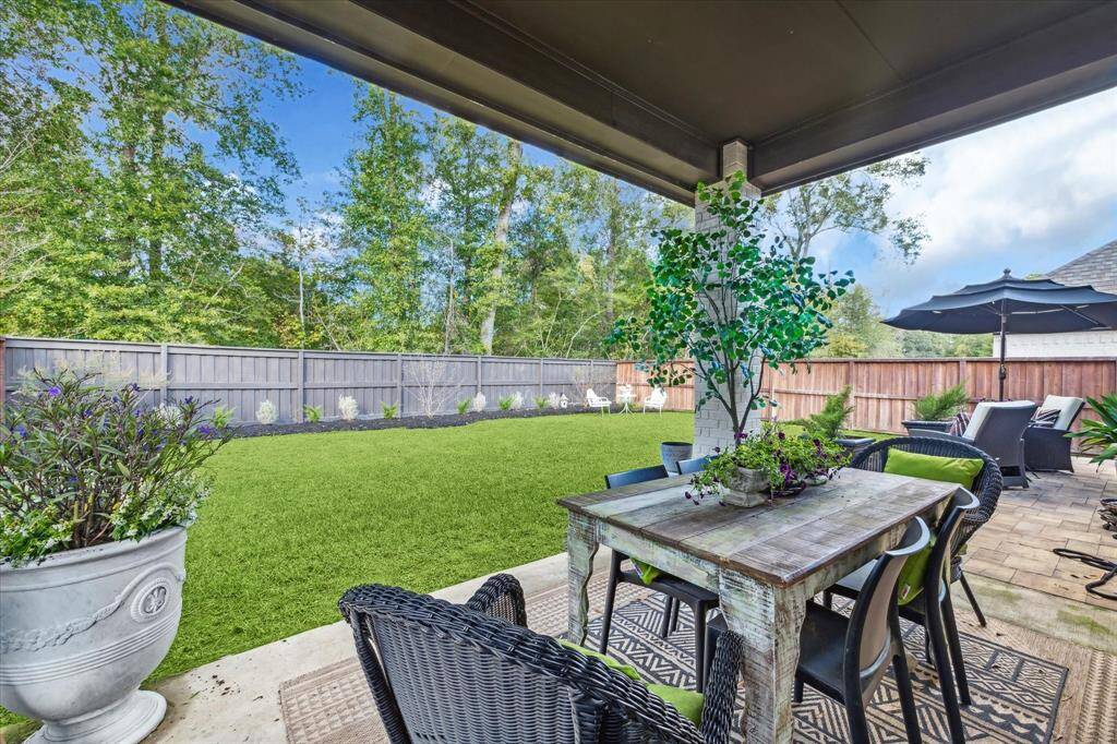 Step right outside and enjoy dining al fresco on your covered patio with an expansive view of the private backyard and trees beyond.