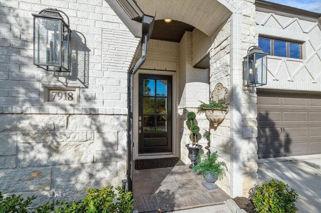A closer view of the front porch. Notice the arched brickwork above, the thin horizontal bricks used on the left and the beautiful stonework.