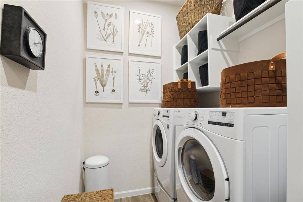 The laundry room has built-in shelving, cubbies and drying rod.