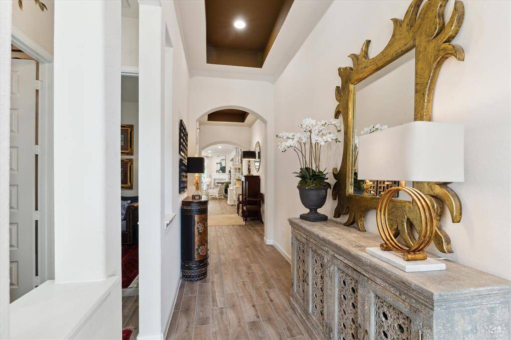 Upon entry, the double arches guide your eye through the extensive entry hall to the rear of the house. Two guest bedrooms, a shared bathroom and a flex space are on the left side.
