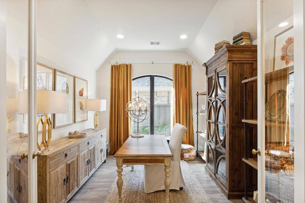 Currently being used as an office, this space could also be a fourth bedroom, media room, playroom, hobby spot or whatever your needs may be!  A large arched window lets in natural light. The lined curtains are from Ballard Designs and are draped on a clear acrylic rod with acrylic rings, providing an airy appearance.