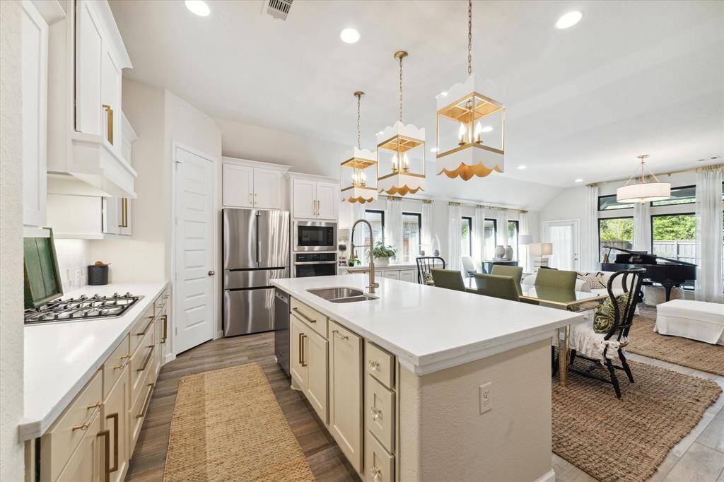 Continuing through the entry hall, the home opens up to an expansive open concept gathering space!