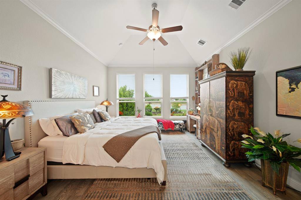 The primary bedroom retreat located at the back of the home and looking over the beautiful backyard views.