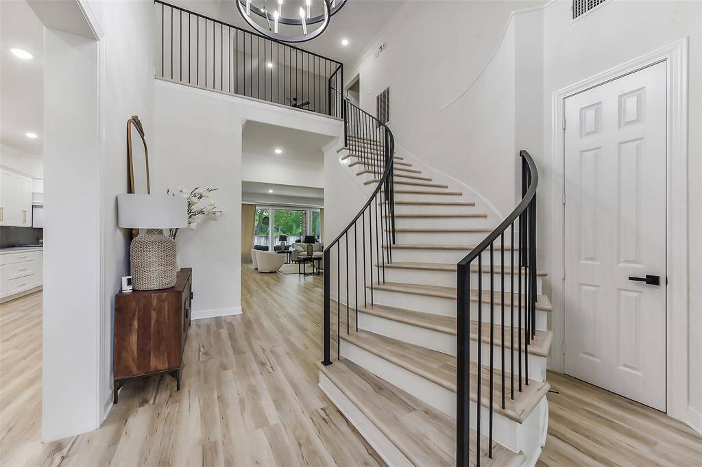 Welcome to your dream home! This stunning entryway features a grand curved staircase and modern design elements, leading to an open-concept living area. Perfect for elegant entertaining or cozy family gatherings.