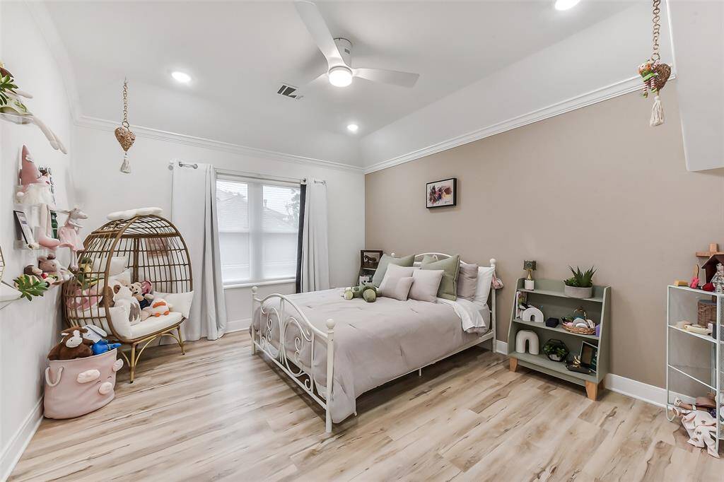 Charming bedroom with modern flooring and soft, neutral tones. Features a cozy reading nook and ample natural light, creating a perfect retreat for relaxation.