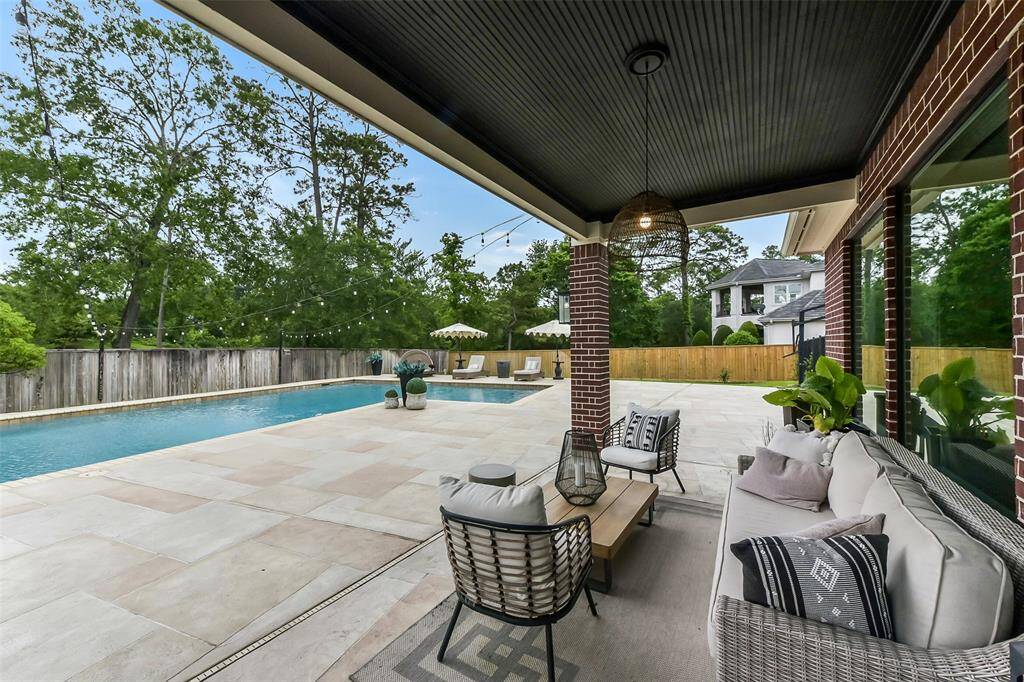 Discover your private oasis with this stunning backyard featuring a sparkling pool and spacious patio. Perfect for relaxation and entertaining, this serene setting is surrounded by lush greenery, offering both privacy and tranquility.