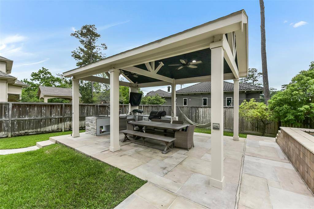 Discover your perfect outdoor retreat with this stylish covered patio, featuring a built-in grill and ample seating for relaxation and entertaining. Ideal for hosting gatherings or enjoying peaceful evenings.