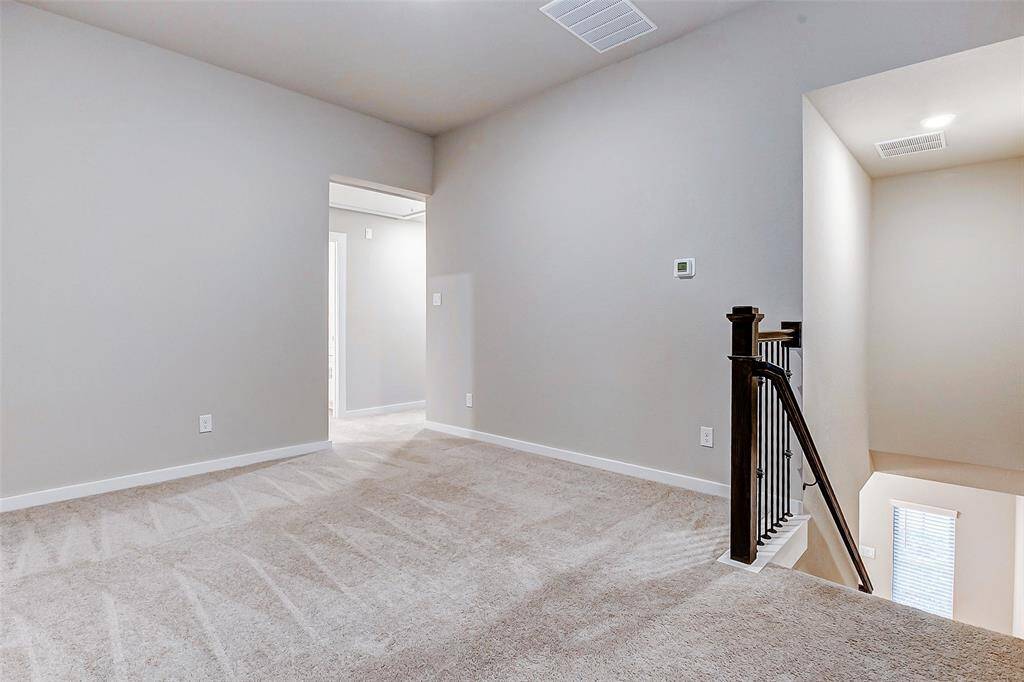 Unwind in this cozy loft space, featuring plush carpeting and abundant natural light. A perfect setting for family movie nights, gaming, or a quiet reading corner.