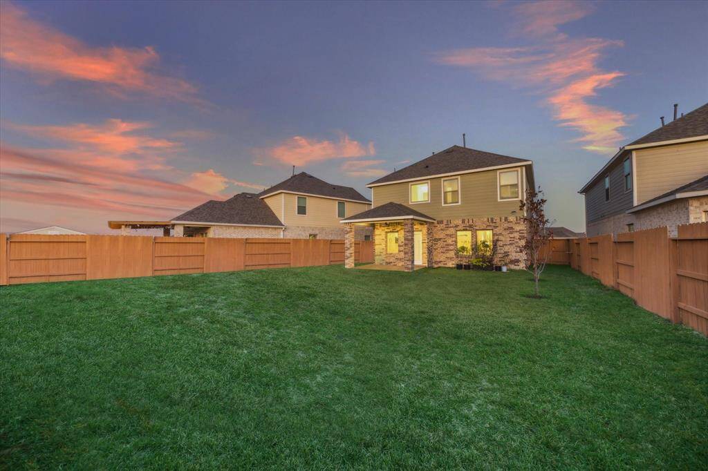 Bask in the beauty of a spacious backyard with a backdrop of stunning sunset hues. Perfect for outdoor activities, this fenced-in yard offers privacy and charm.