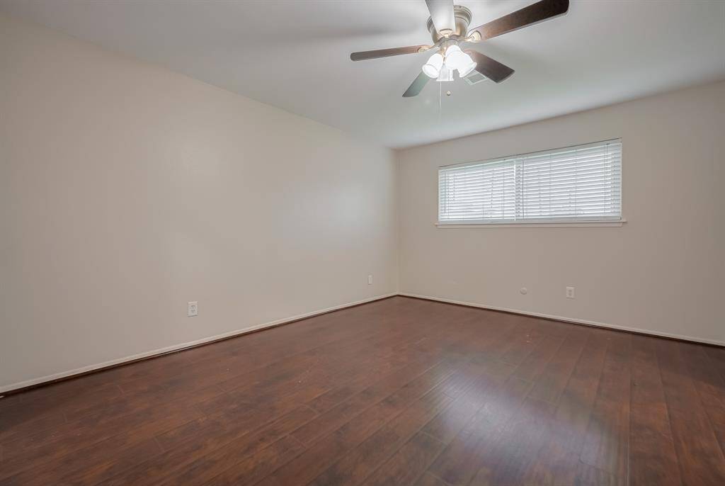 Alternate view of the primary bedroom looking into the backyard.