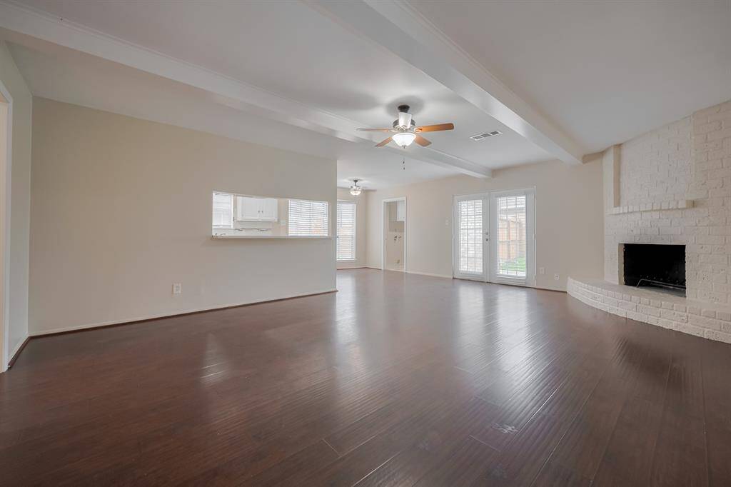 An inviting living room with a gas fireplace and direct access to the backyard.