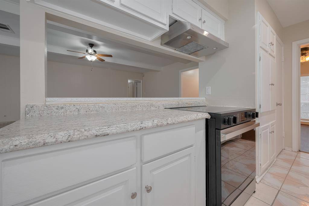 Newly installed dishwasher, electric range and vent with ample cabinetry.