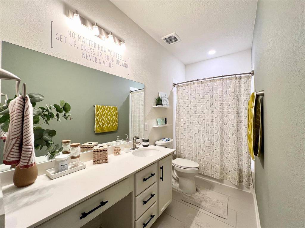 Bathroom 2 with large vanity space including knee space to sit.