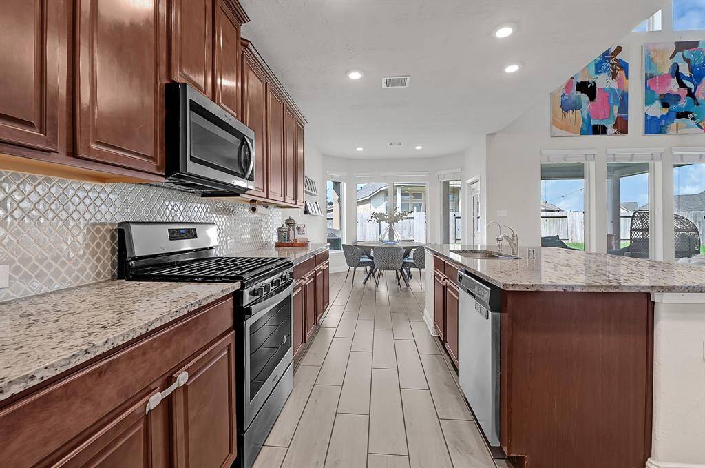 You'll never be left out while cooking, again! Imagine gathering around the granite island serving finger foods at a casual get-together or birthday party. Your gorgeous new kitchen seamlessly flows into the dining area at the rear of the home.